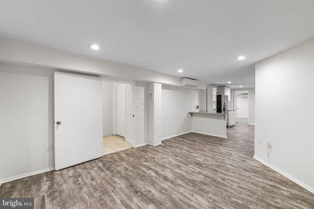 basement with light hardwood / wood-style flooring