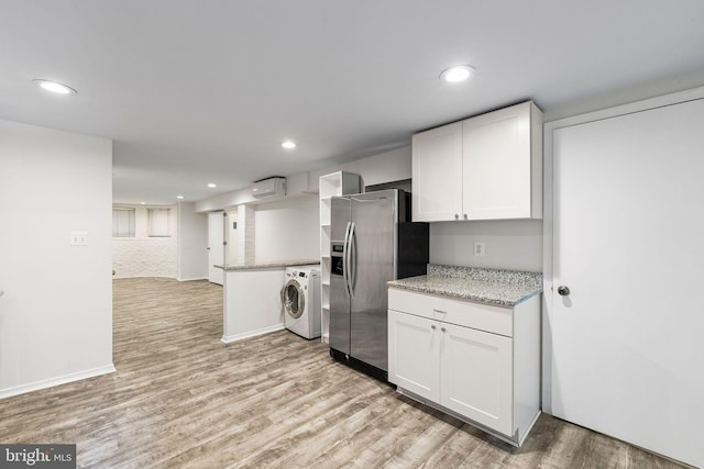 kitchen with white cabinets, stainless steel refrigerator with ice dispenser, light hardwood / wood-style flooring, an AC wall unit, and washer / dryer