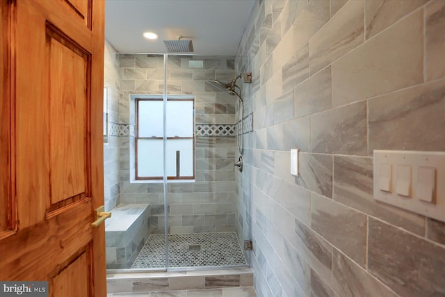 bathroom featuring a shower with shower door