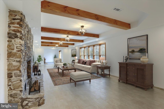 living room with beam ceiling, a fireplace, and a chandelier