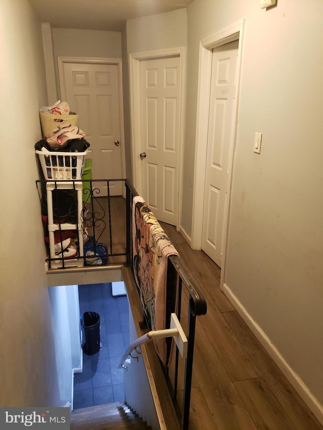 corridor with dark hardwood / wood-style flooring