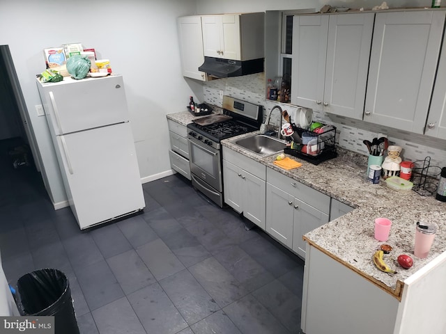 kitchen with white fridge, white cabinetry, range hood, and gas range