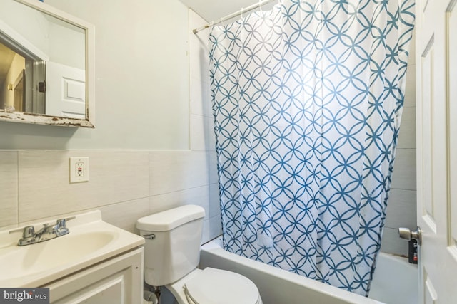 full bathroom with tile walls, vanity, toilet, and shower / bathtub combination with curtain