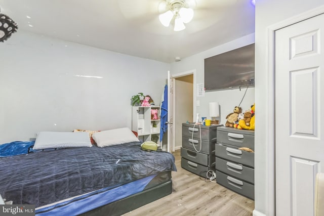 bedroom with ceiling fan and light hardwood / wood-style flooring