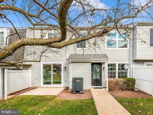 back of property featuring central air condition unit, a yard, and a patio area