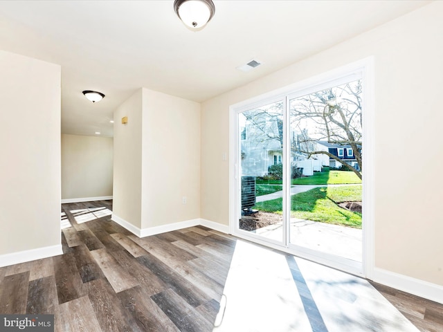 unfurnished room featuring dark hardwood / wood-style floors