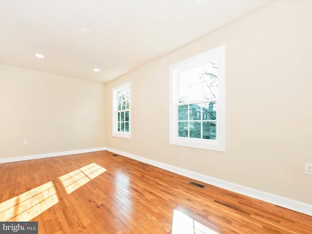 unfurnished room featuring light hardwood / wood-style floors