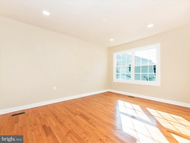 empty room with light hardwood / wood-style flooring