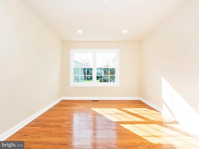 empty room with light hardwood / wood-style flooring