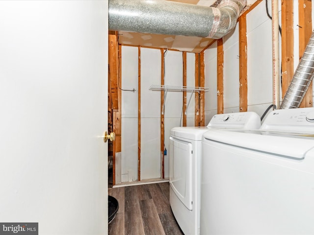 laundry area with dark wood-type flooring and independent washer and dryer