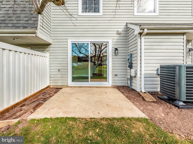 doorway to property with a patio and central AC