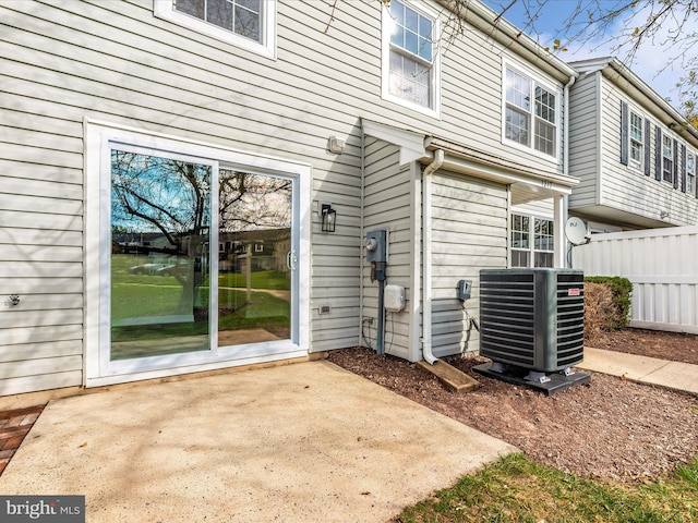 doorway to property featuring a patio area and cooling unit