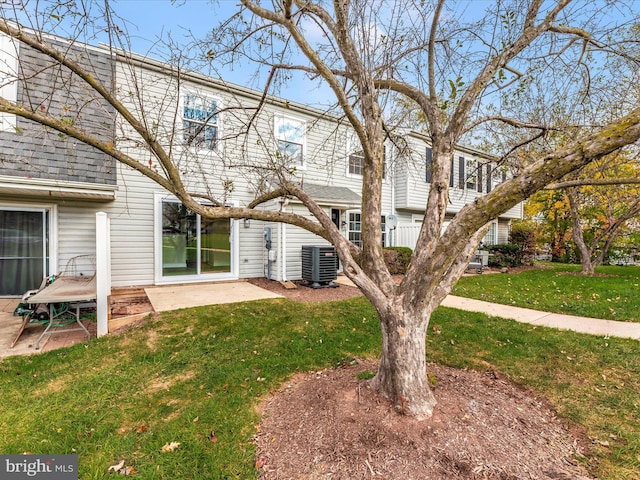 exterior space featuring a patio area, central AC, and a lawn