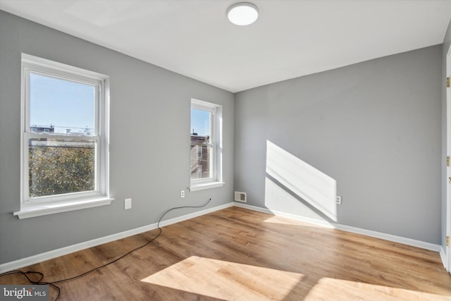 unfurnished room with light hardwood / wood-style floors