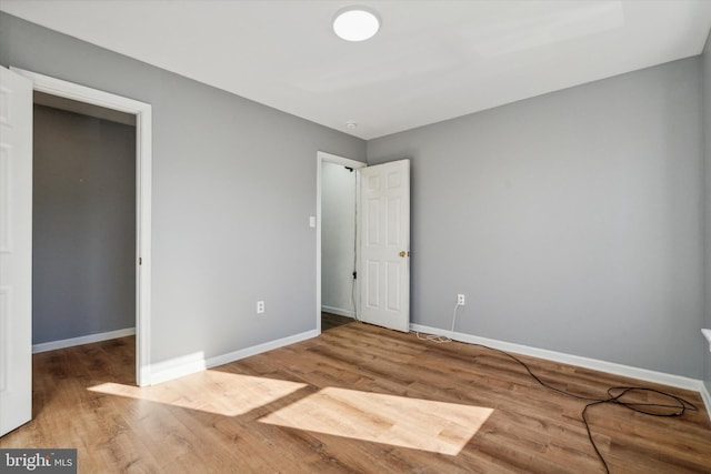 unfurnished bedroom with wood-type flooring