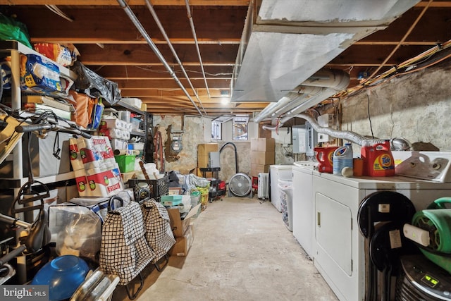 basement with electric panel and washing machine and dryer