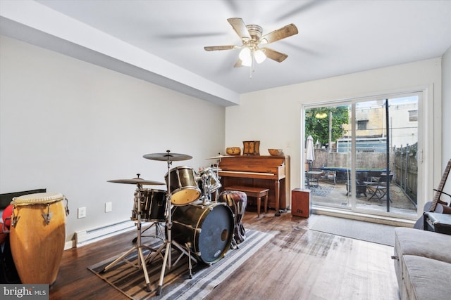 misc room featuring a baseboard radiator, hardwood / wood-style flooring, and ceiling fan