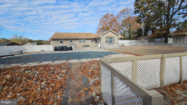 rear view of property with a patio and a covered pool