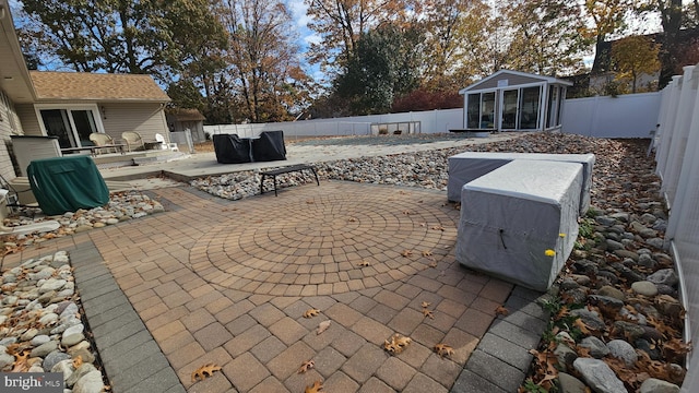 view of patio / terrace featuring a sunroom