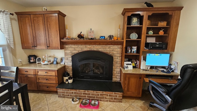 office with a fireplace and light tile patterned floors