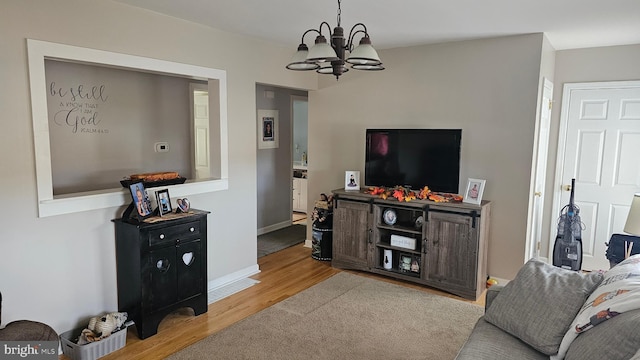 living room with a chandelier and wood-type flooring