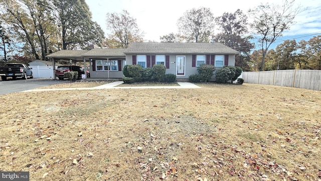 ranch-style home with a front lawn and a carport