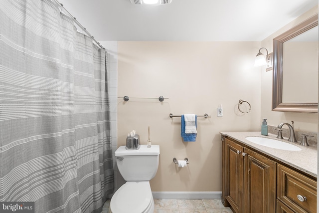 bathroom featuring vanity, tile patterned floors, and toilet