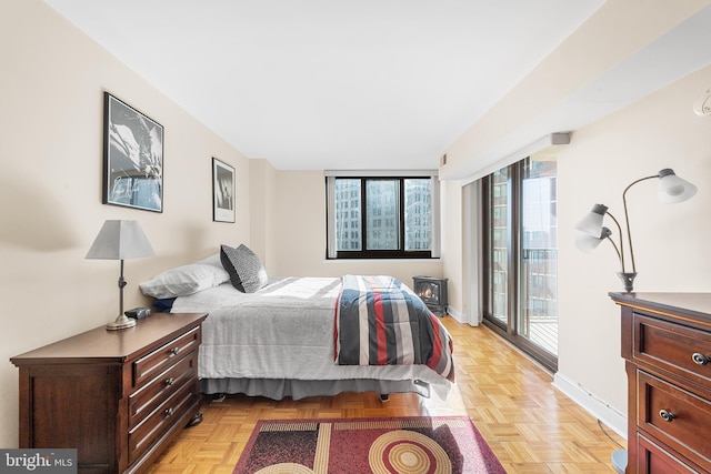 bedroom featuring light parquet floors and access to outside