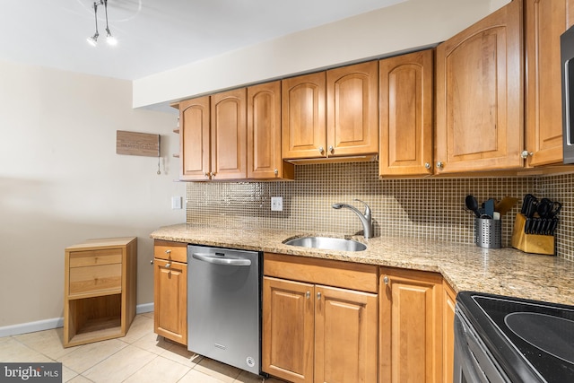 kitchen featuring stainless steel appliances, sink, tasteful backsplash, and light stone countertops