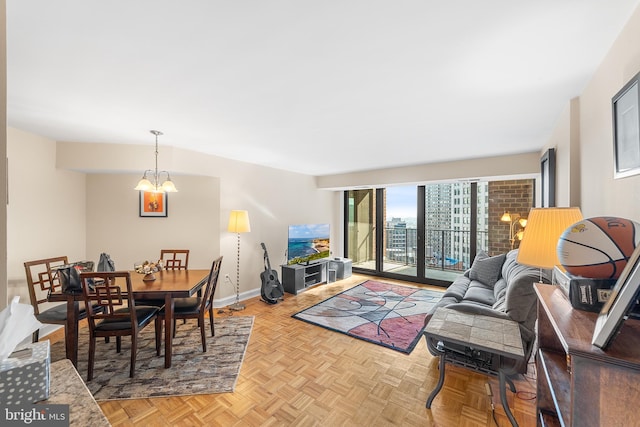 living room featuring light parquet flooring and a chandelier