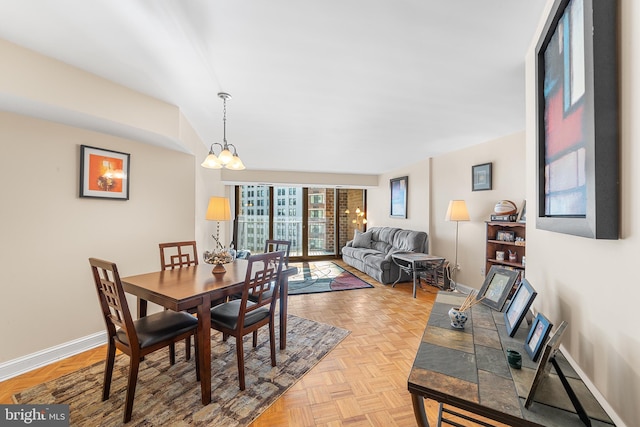 dining area with light parquet floors and a notable chandelier