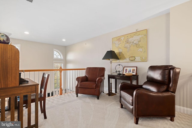 living area with light colored carpet