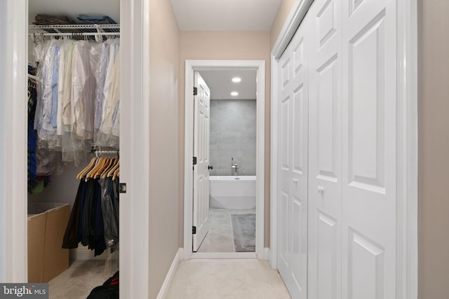 hallway with light colored carpet