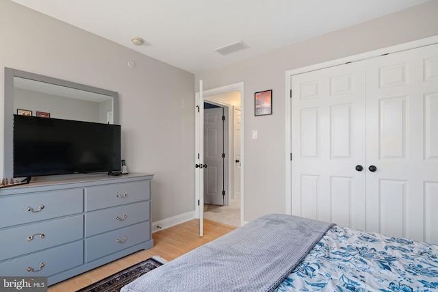 bedroom featuring light hardwood / wood-style floors and a closet