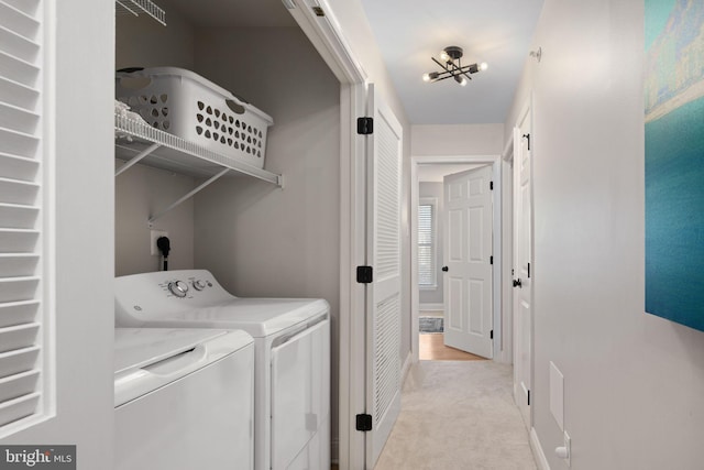 washroom featuring light colored carpet, a notable chandelier, and washer and dryer