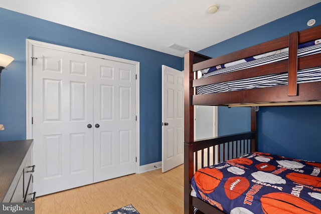 bedroom featuring a closet and light wood-type flooring