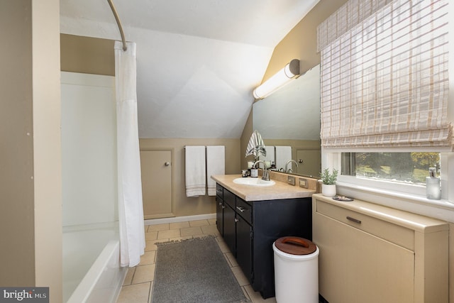 bathroom with vanity, tile patterned flooring, shower / bathtub combination with curtain, and vaulted ceiling