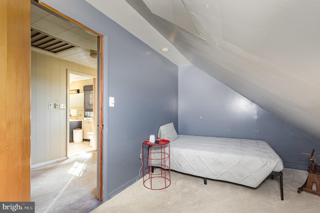 bedroom featuring light carpet and vaulted ceiling