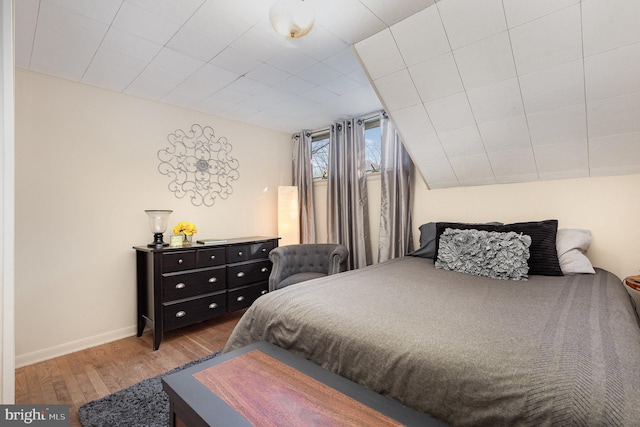 bedroom featuring baseboards and wood finished floors