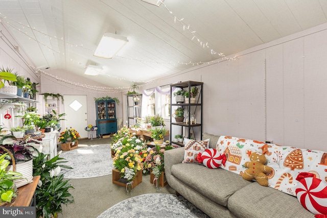 carpeted living room featuring vaulted ceiling