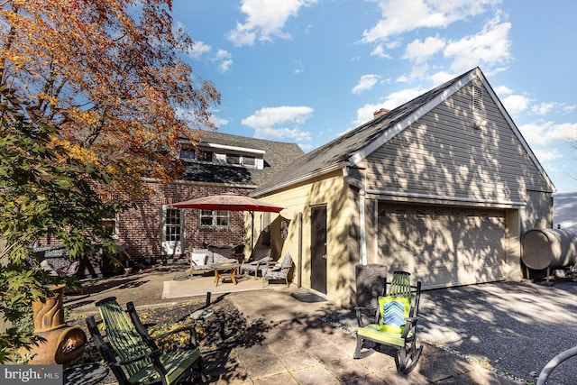 view of home's exterior featuring a garage and a patio