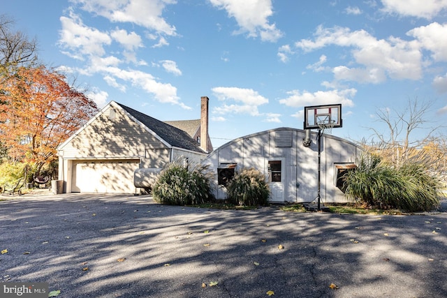view of front of property with aphalt driveway and an attached garage
