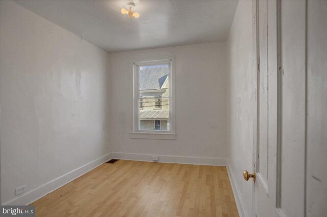 spare room featuring light hardwood / wood-style flooring