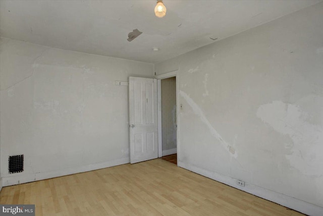 spare room featuring light hardwood / wood-style floors