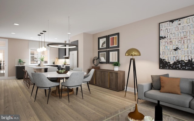 dining room with light wood-type flooring and a notable chandelier