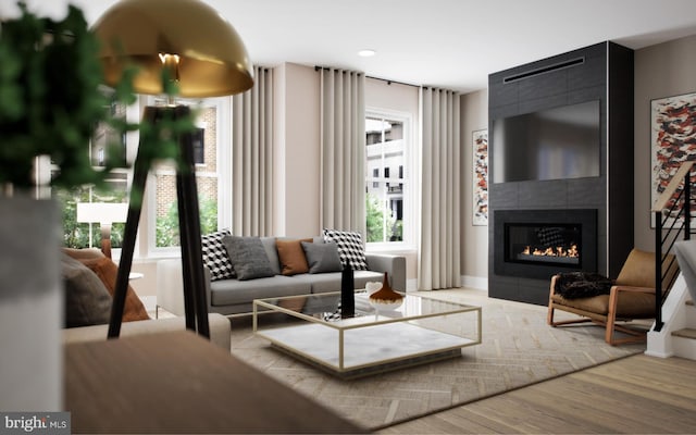 living room featuring wood-type flooring and a fireplace