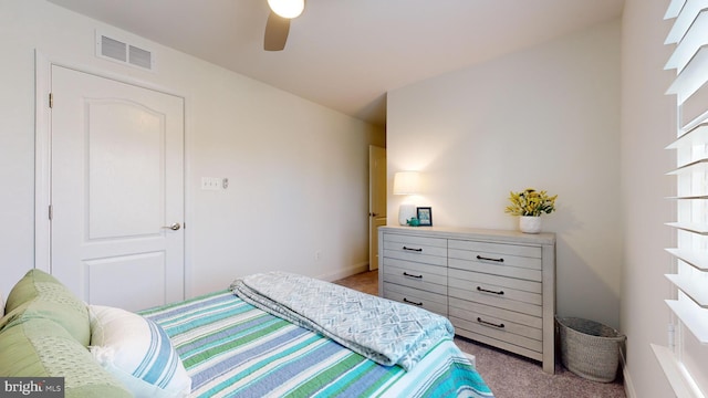 bedroom featuring light colored carpet and ceiling fan