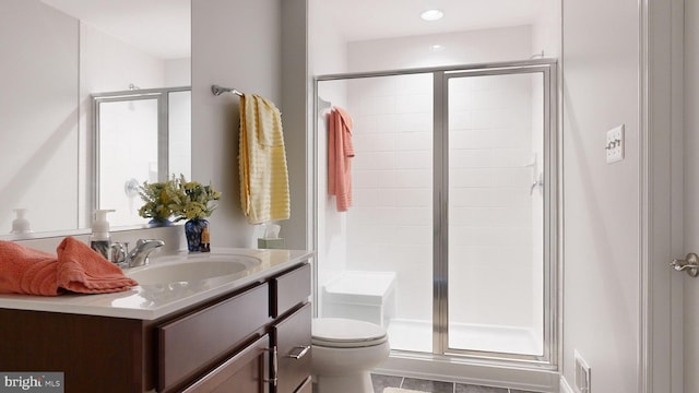 bathroom with walk in shower, tile patterned flooring, vanity, and toilet