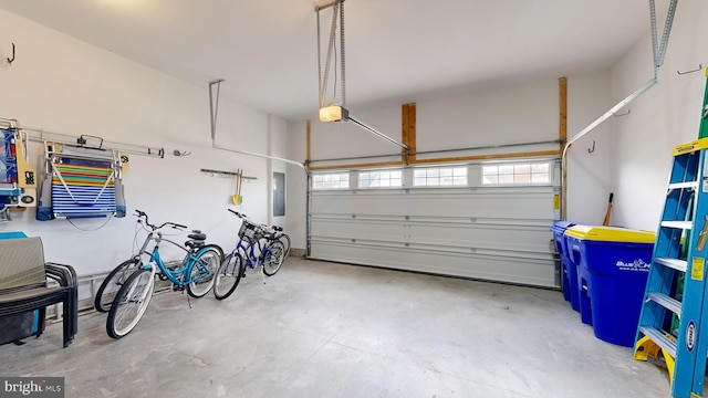 garage featuring electric panel and a garage door opener