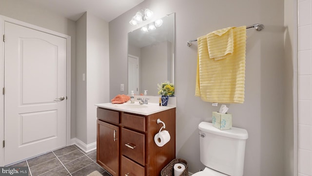 bathroom featuring toilet, vanity, and tile patterned floors